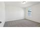 Bright bedroom features neutral carpet and white walls with a window for natural light at 4034 Copperleaf Ln, Poinciana, FL 34759