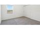 Carpeted bedroom with closet offers a view from the window at 4034 Copperleaf Ln, Poinciana, FL 34759