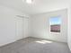 Cozy bedroom with closet, carpeted floor, and natural light from the window at 4034 Copperleaf Ln, Poinciana, FL 34759
