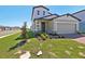 Charming two-story home with an attached two-car garage, complemented by green lawn at 4034 Copperleaf Ln, Poinciana, FL 34759