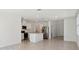 Modern kitchen with stainless steel appliances, white cabinets, and an island at 4034 Copperleaf Ln, Poinciana, FL 34759
