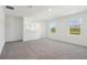 Bright living room with plush carpeting and large windows with beautiful views at 4034 Copperleaf Ln, Poinciana, FL 34759