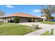 Exterior view of home with a well-manicured lawn and landscaping, including a large driveway and an attached garage at 4442 Tidewater Dr, Orlando, FL 32812