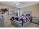 Bedroom with a floral comforter, nightstand and ceiling fan at 4460 Perkinshire Ln # 205, Orlando, FL 32822