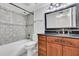 Bathroom featuring a decorative vanity, mirror, and tiled shower at 530 E Central Blvd # 102, Orlando, FL 32801