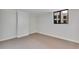 A small bedroom with neutral walls, neutral carpet, and a window with a view at 530 E Central Blvd # 102, Orlando, FL 32801