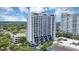 A high rise condo building with an intricate balcony design stands out against lush green landscape under bright blue skies at 530 E Central Blvd # 102, Orlando, FL 32801