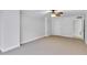 A spacious living room has neutral colored walls, neutral carpet, and a ceiling fan at 530 E Central Blvd # 102, Orlando, FL 32801