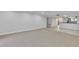 Open-concept living room with neutral carpeting, tile flooring, and a breakfast bar overlooking the kitchen at 530 E Central Blvd # 102, Orlando, FL 32801