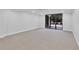 Spacious living room with neutral carpeting, sliding glass doors leading to the backyard, and recessed lighting at 530 E Central Blvd # 102, Orlando, FL 32801