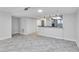Open-concept living room boasts light gray tile flooring, neutral walls, and a breakfast bar overlooking the kitchen at 530 E Central Blvd # 102, Orlando, FL 32801