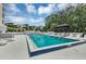 Resort-style pool area with lounge chairs, lush greenery, and city views at 530 E Central Blvd # 102, Orlando, FL 32801