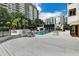 Outdoor pool with lounge chairs surrounded by tropical landscaping and city views at 530 E Central Blvd # 102, Orlando, FL 32801