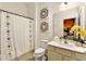 Clean bathroom with a shower/tub combo, vanity, and neutral decor at 5414 Oakgrain Ct, Davenport, FL 33837