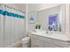 Clean bathroom with white vanity, a shower/tub combo and decorative shower curtain at 5414 Oakgrain Ct, Davenport, FL 33837