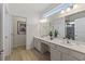 Double vanity bathroom with modern fixtures and large mirror at 5414 Oakgrain Ct, Davenport, FL 33837