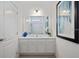 Bathroom with a vanity, large mirror, and a clean design at 5414 Oakgrain Ct, Davenport, FL 33837