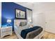 Serene bedroom with a white bed frame and blue accent wall at 5414 Oakgrain Ct, Davenport, FL 33837