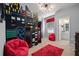 A bedroom with bunk beds and red beanbag chairs, featuring a city-themed design at 5414 Oakgrain Ct, Davenport, FL 33837