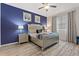 Bedroom with a plush bed, nightstands, and a blue accent wall at 5414 Oakgrain Ct, Davenport, FL 33837
