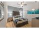 Primary bedroom with a brown upholstered bed and teal artwork at 5414 Oakgrain Ct, Davenport, FL 33837