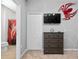 Bedroom with a dresser and TV, featuring a spider-themed wall decor at 5414 Oakgrain Ct, Davenport, FL 33837