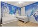 Twin bedroom with Frozen mural and light wood flooring at 5414 Oakgrain Ct, Davenport, FL 33837