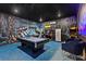 Game room with Batman-themed decor, pool table and arcade games at 5414 Oakgrain Ct, Davenport, FL 33837