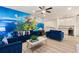 Gathering room with Neverland mural, comfy sofas, and wet bar at 5414 Oakgrain Ct, Davenport, FL 33837