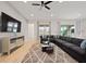 Open living room featuring a sectional sofa and large TV at 5414 Oakgrain Ct, Davenport, FL 33837