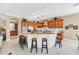 Well-appointed kitchen featuring a breakfast bar, granite countertops, and modern appliances at 6234 Foxfield Ct, Windermere, FL 34786