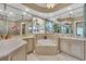 Elegant main bathroom with dual vanities, tub and mirrored accents at 6234 Foxfield Ct, Windermere, FL 34786