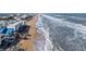 Aerial view of beachfront homes and ocean waves at 6815 Engram Rd, New Smyrna Beach, FL 32169