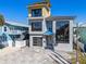 Modern three-story home with gray exterior and large windows at 6815 Engram Rd, New Smyrna Beach, FL 32169