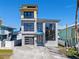 Modern three-story home with dark gray exterior at 6815 Engram Rd, New Smyrna Beach, FL 32169