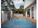 Relaxing pool area with a pergola, waterfall feature, and outdoor kitchen at 6815 Engram Rd, New Smyrna Beach, FL 32169