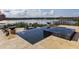 A modern pool features a tiled hot tub and water fountain feature overlooking a scenic lake under a sunny sky at 7631 Toscana Blvd, Orlando, FL 32819