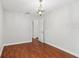 Bedroom featuring laminate wood flooring, base trim, a chandelier, and a closet at 7943 Snowberry Cir, Orlando, FL 32819