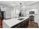 Modern kitchen featuring stone countertops, stainless steel appliances, and pendant lighting at 7943 Snowberry Cir, Orlando, FL 32819