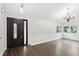 Bright living room featuring wood floors, chandelier, wainscotting, and plenty of natural light at 7943 Snowberry Cir, Orlando, FL 32819