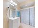 Clean bathroom with white vanity, shower/tub combo, and teal towels at 8013 Cool Breeze Dr # 116, Orlando, FL 32819