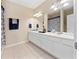 Double-sink bathroom with white vanity and navy blue accents at 8013 Cool Breeze Dr # 116, Orlando, FL 32819