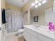 Bathroom with white vanity, shower/tub combo and dog-themed decor at 8013 Cool Breeze Dr # 116, Orlando, FL 32819