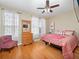 Bedroom with queen bed, hardwood floors, and ceiling fan at 8013 Cool Breeze Dr # 116, Orlando, FL 32819