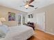 Comfortable bedroom with hardwood floors, a ceiling fan, and access to a patio at 8013 Cool Breeze Dr # 116, Orlando, FL 32819