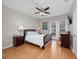 Spacious bedroom with hardwood floors, ceiling fan, and access to patio at 8013 Cool Breeze Dr # 116, Orlando, FL 32819