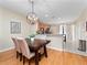 Dining area adjacent to kitchen with dark wood table and chairs at 8013 Cool Breeze Dr # 116, Orlando, FL 32819