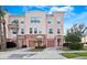 Three-story townhome with two-car garage and landscaped front at 8013 Cool Breeze Dr # 116, Orlando, FL 32819
