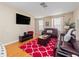 Living room with hardwood floors, leather couches, and large TV at 8013 Cool Breeze Dr # 116, Orlando, FL 32819