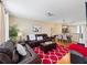 Spacious living room featuring comfortable leather furniture and a red area rug at 8013 Cool Breeze Dr # 116, Orlando, FL 32819